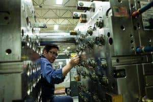 hoffer plastics employee working on machine